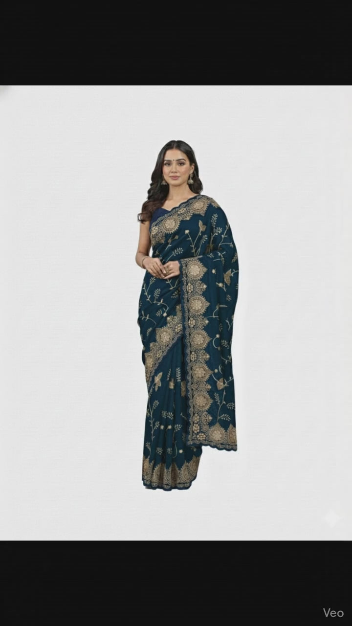 Jwalamukhi Silk Premium Saree in Teal Blue with Gold Zari Border & Floral Design – Elegant Traditional Wear